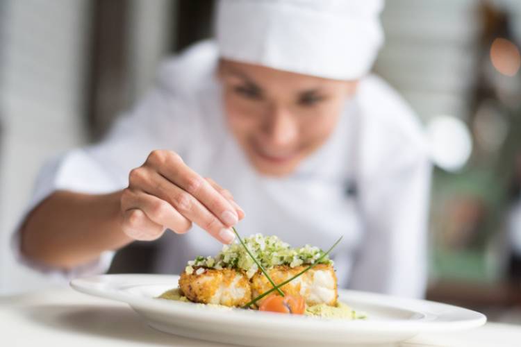 A chef plates a dish