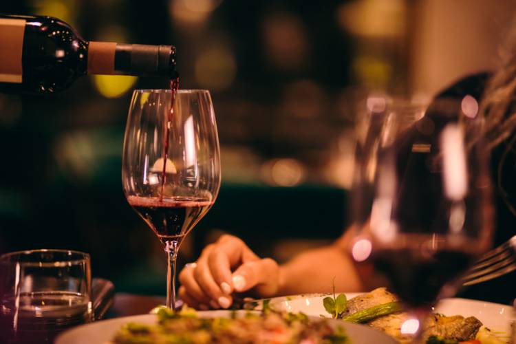 Wine is poured at a fine dining restaurant 