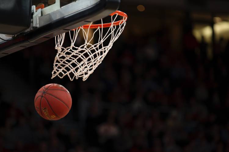 basketball in air moving toward basketball hoop