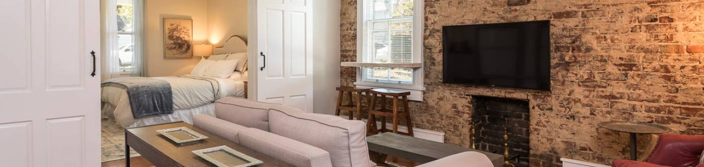 Pictured: French Cottage Apartment living room looking into bedroom